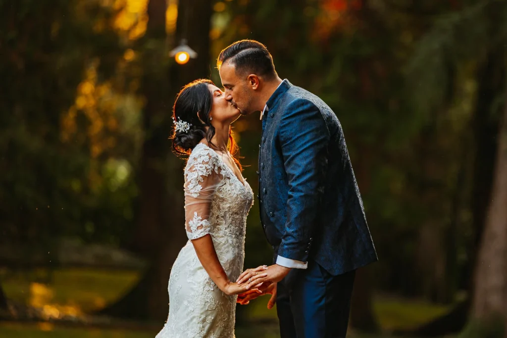 Bride and groom sharing a kiss in the romantic garden of Villa Acquaroli
