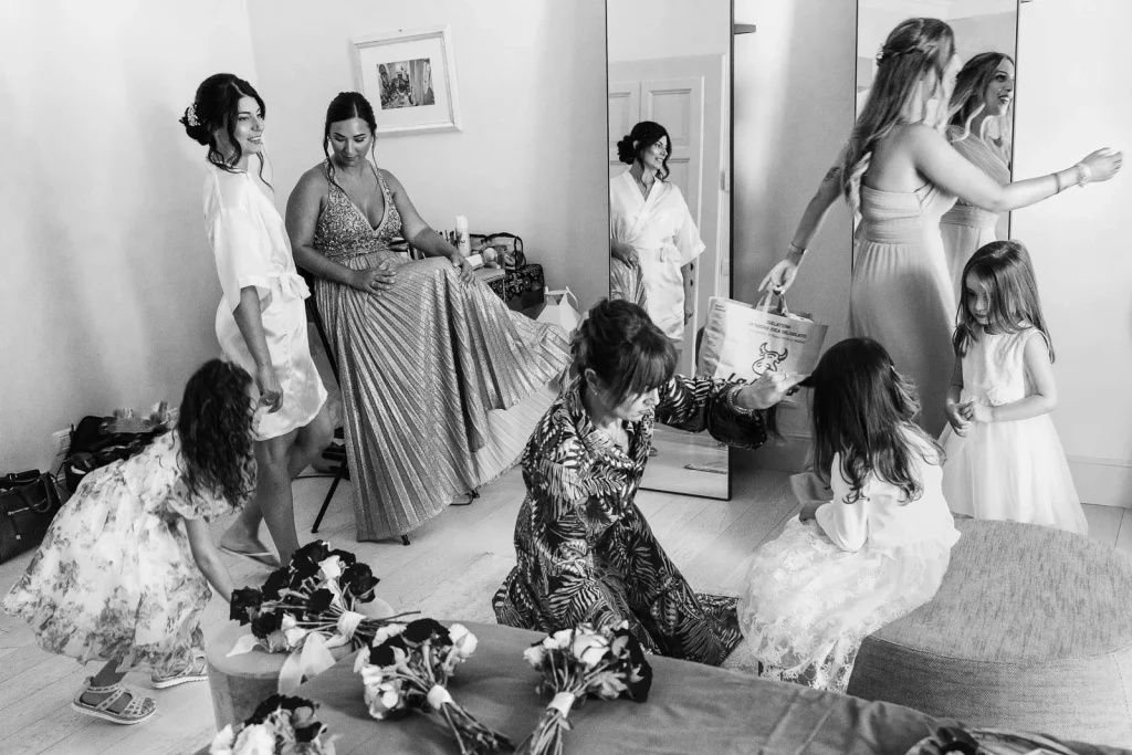 Bridesmaids helping the bride with her dress