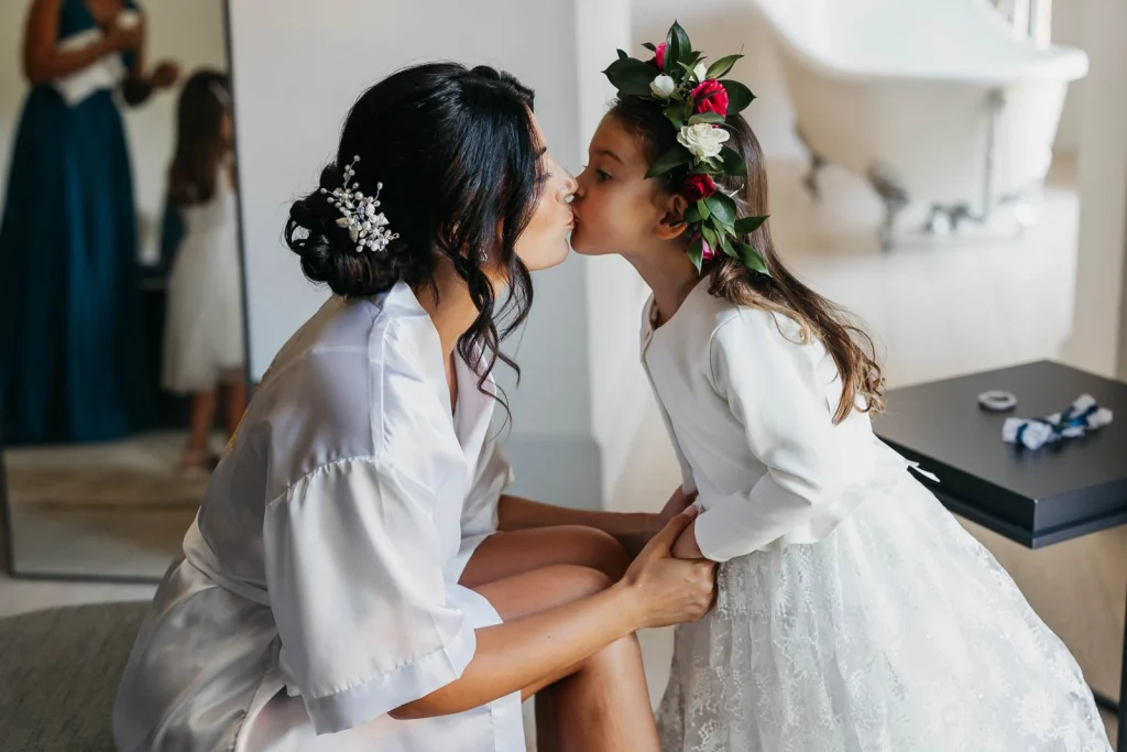 Bride and daughter sharing a sweet kiss before the ceremony