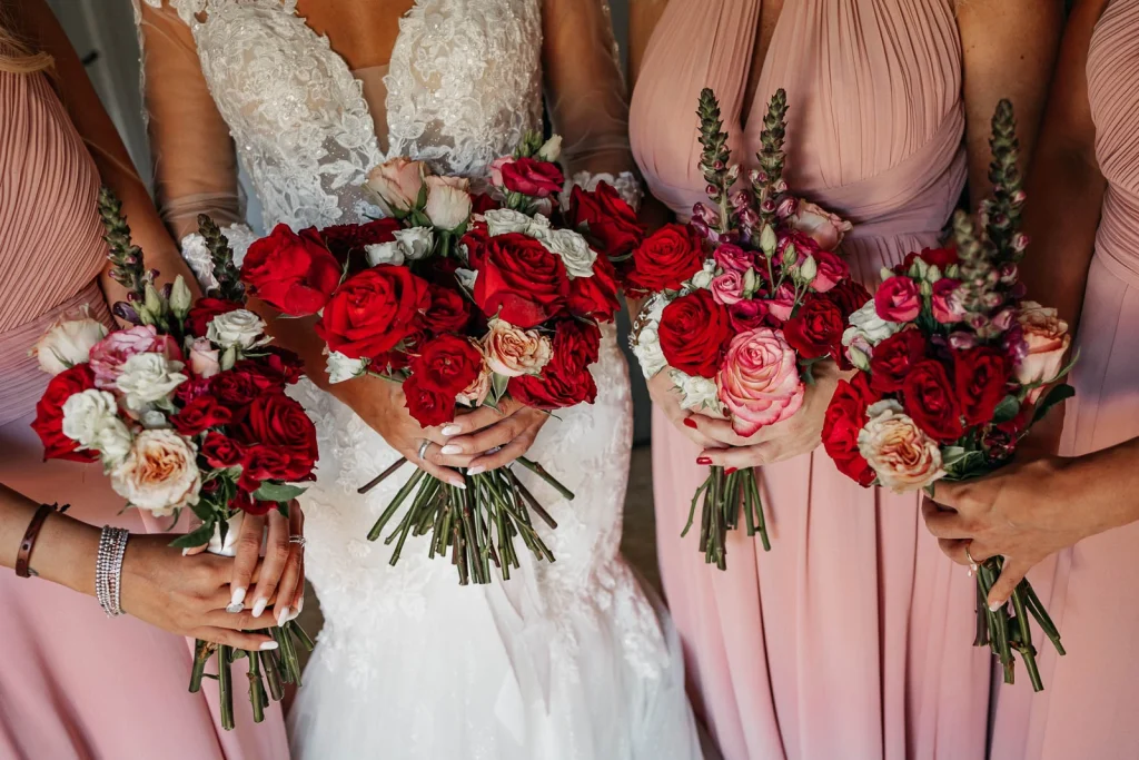 Bridal bouquet with red, pink, and ivory roses