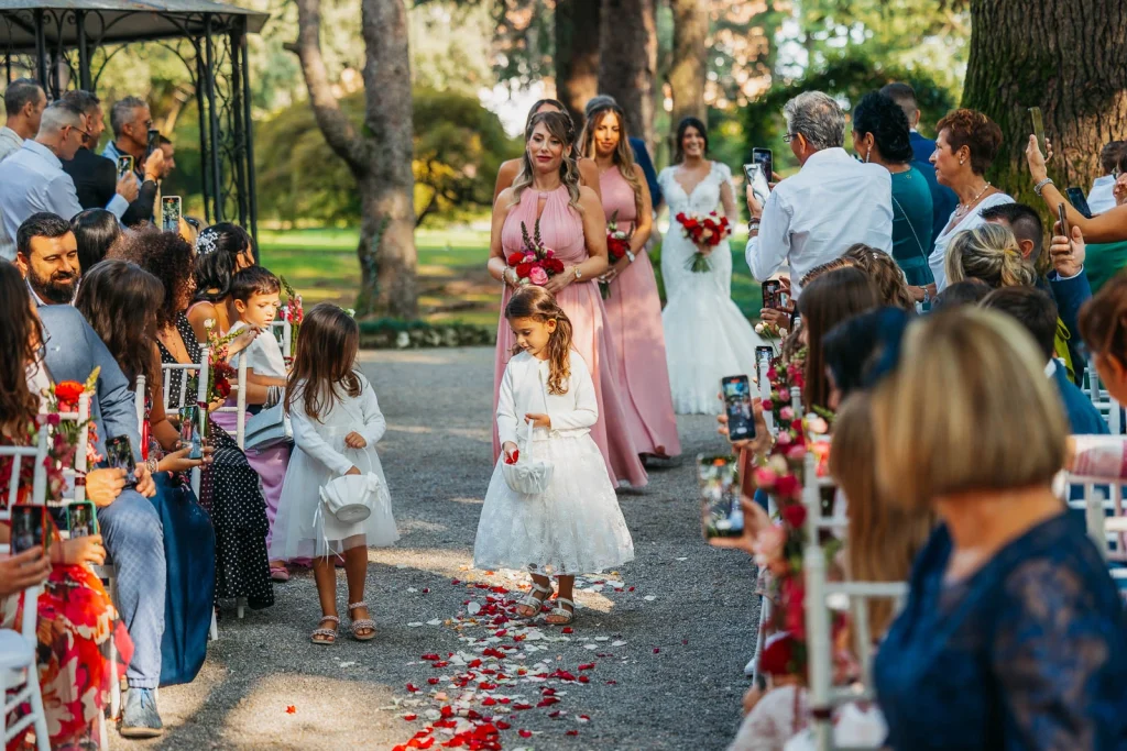 Flower girls walking down the aisle with petals