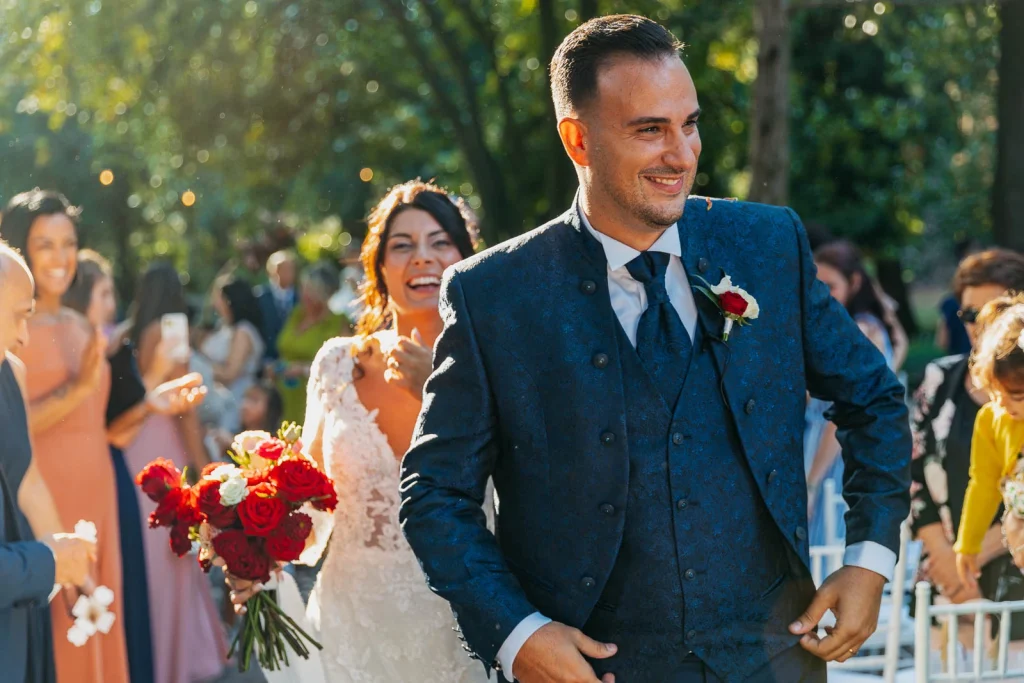 Groom smiling proudly with bride after the ceremony