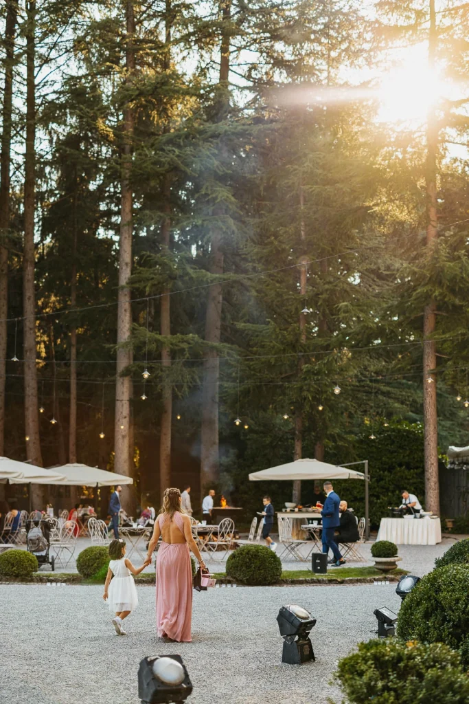 Aperitivo setup in the villa’s garden surrounded by trees