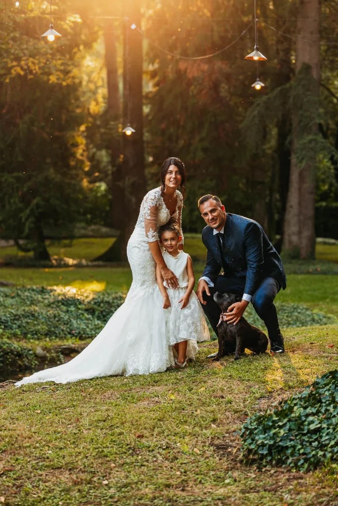  Bride and groom posing with their daughter in the garden