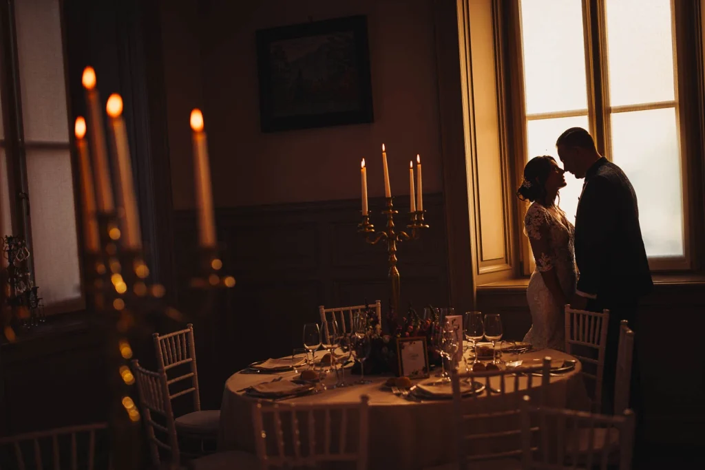 Wedding reception dinner setup with candles and golden lights
