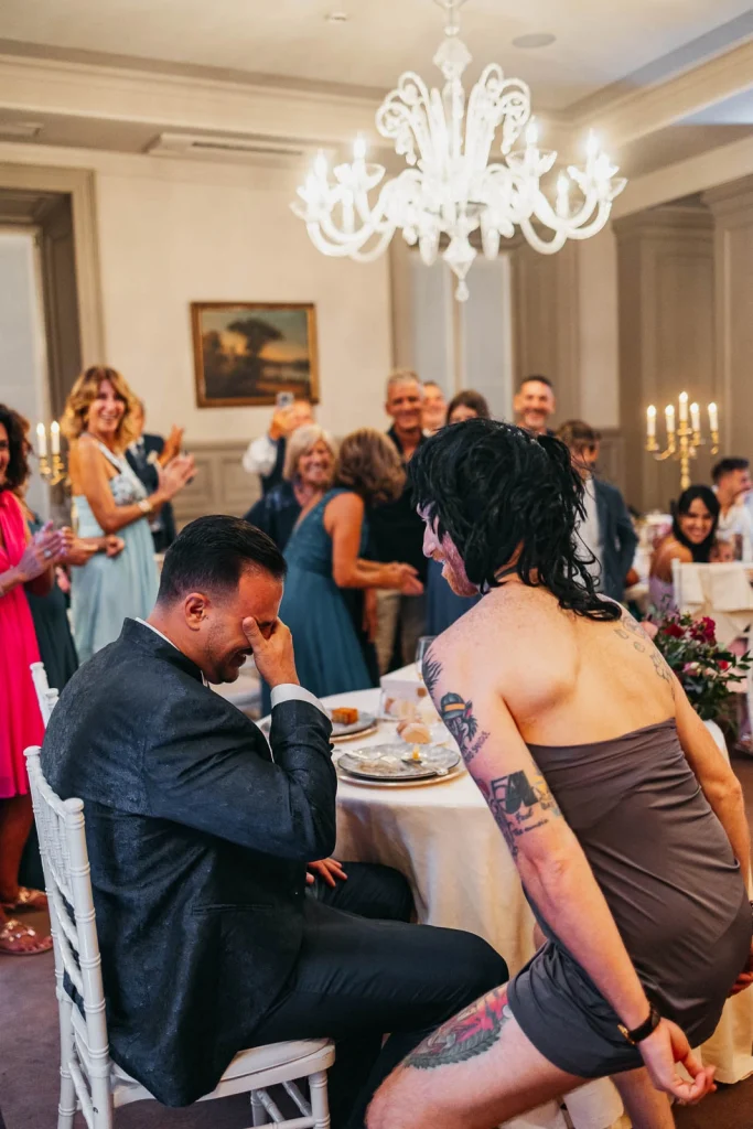 Bride and groom cutting a red floral wedding cake