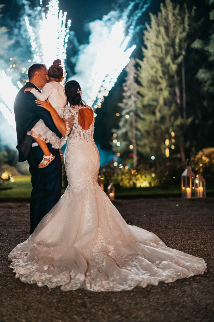 Groom holding bride in the garden after dinner