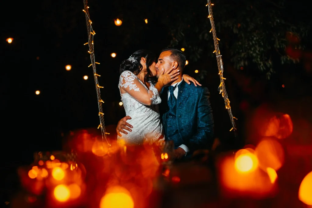 Newlyweds dancing surrounded by twinkling fairy lights