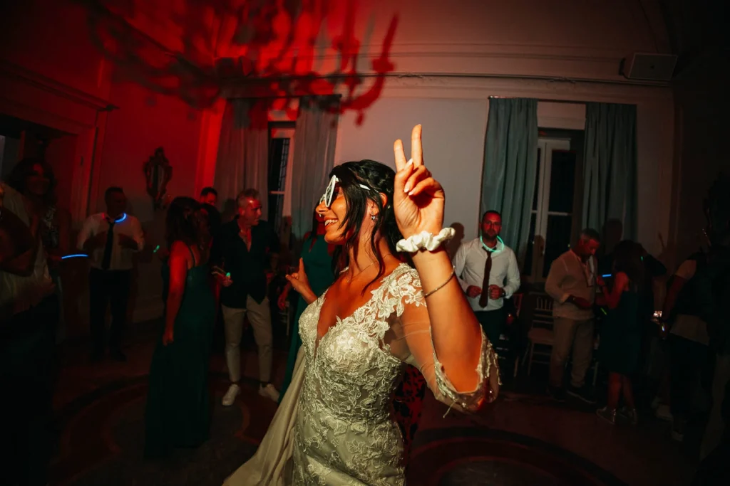 Bride dancing with her hand raised