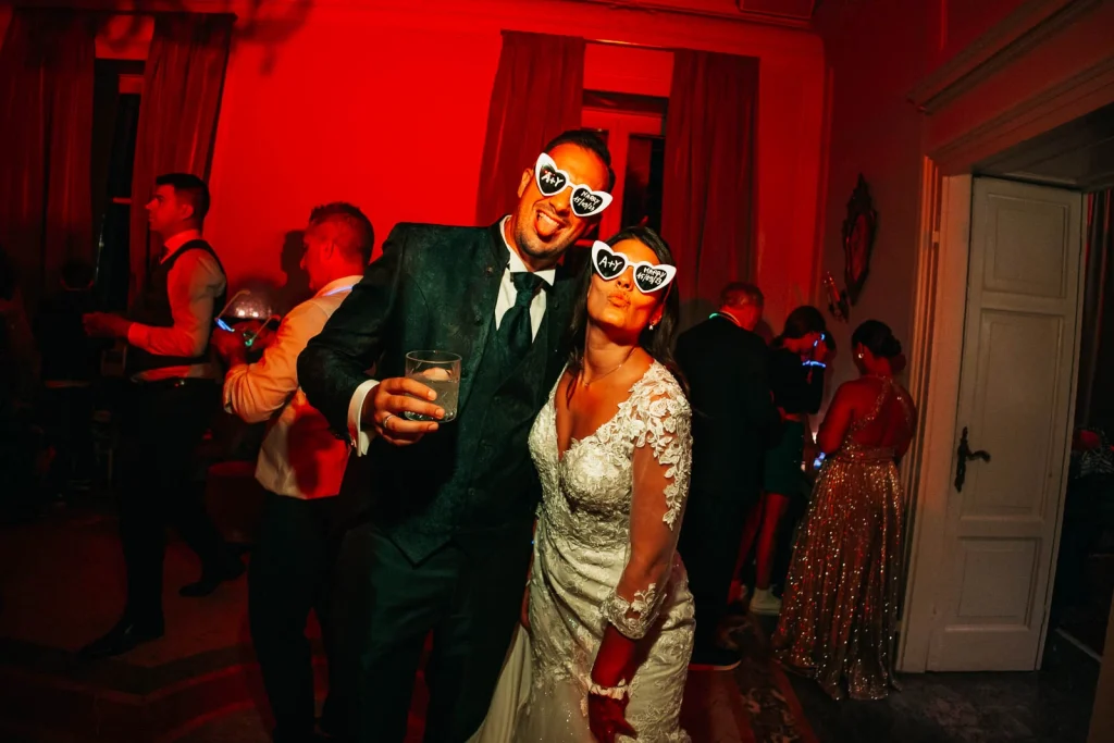 Bride and groom in funny glasses dancing together