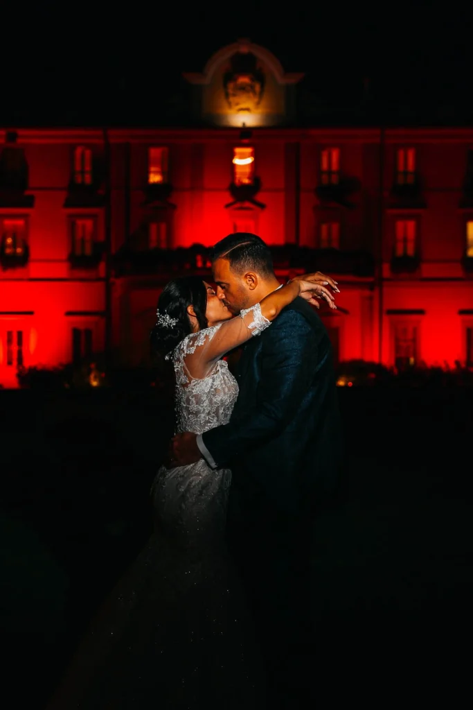 Romantic kiss under warm red lights
