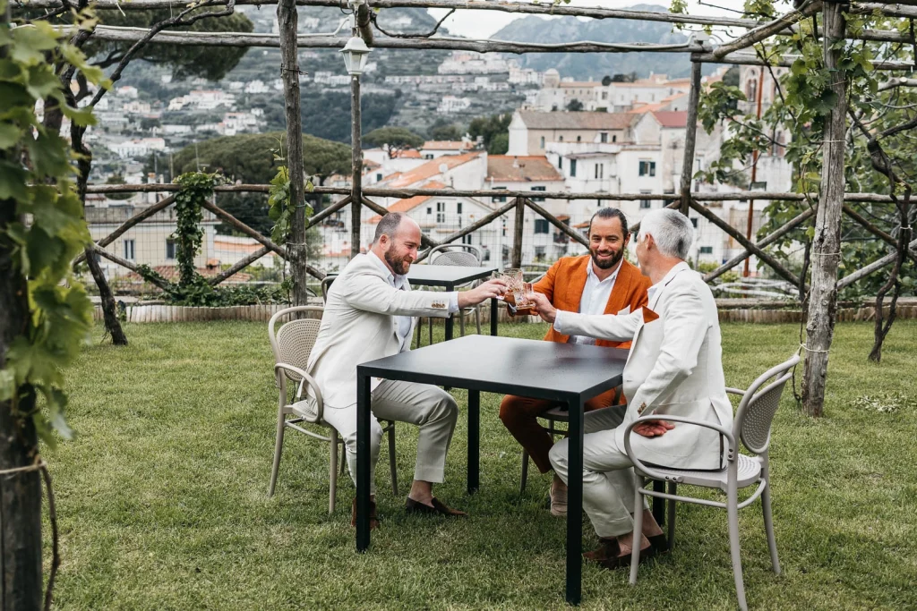 Ravello Wedding at Belmond Hotel Caruso – Amalfi Coast Destination Wedding 17 Wedding guests chatting with drinks and views of Ravello