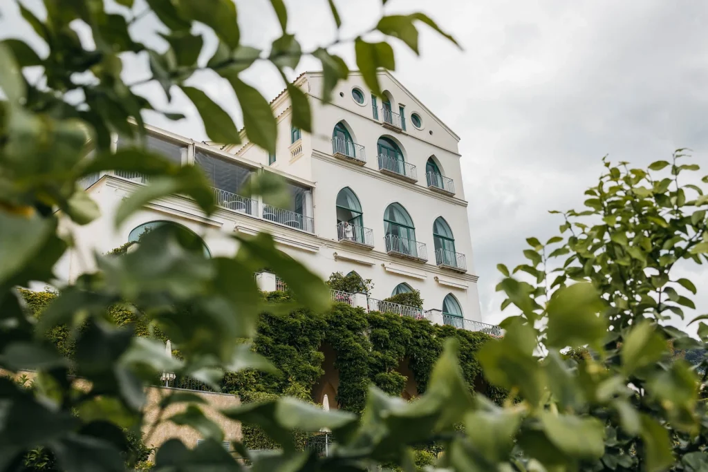 Ravello Wedding at Belmond Hotel Caruso – Amalfi Coast Destination Wedding 3 White façade of Belmond Hotel Caruso surrounded by greenery