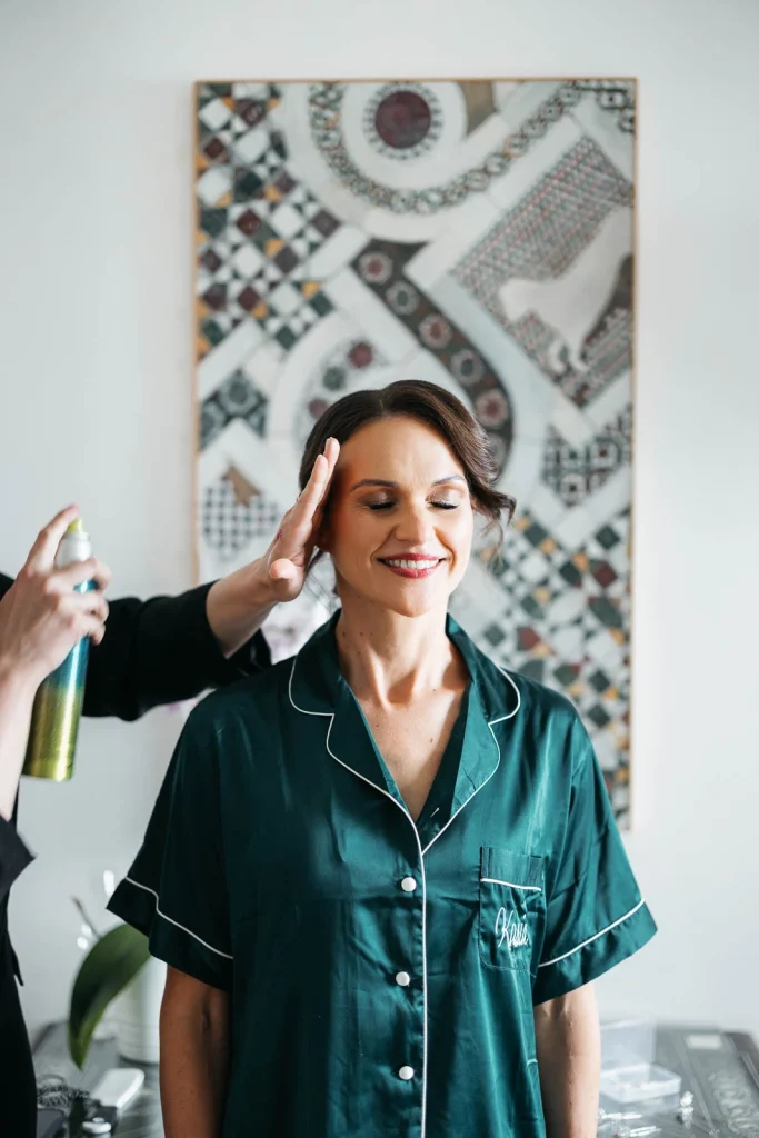 Ravello Wedding at Belmond Hotel Caruso – Amalfi Coast Destination Wedding 23 Bride getting her makeup done while smiling in her green robe at Belmond Hotel Caruso