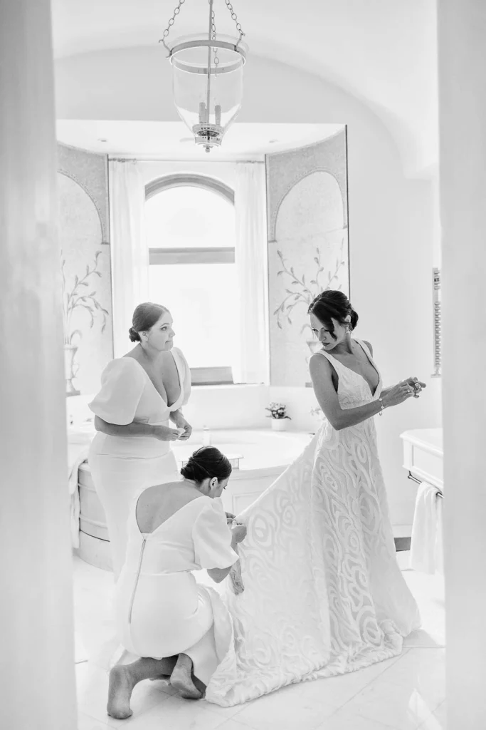 Ravello Wedding at Belmond Hotel Caruso – Amalfi Coast Destination Wedding 26 Bride dressing with help from daughter and bridesmaid in hotel bathroom