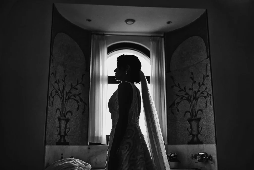 Ravello Wedding at Belmond Hotel Caruso – Amalfi Coast Destination Wedding 27 Silhouette of bride standing in dramatic light inside the hotel