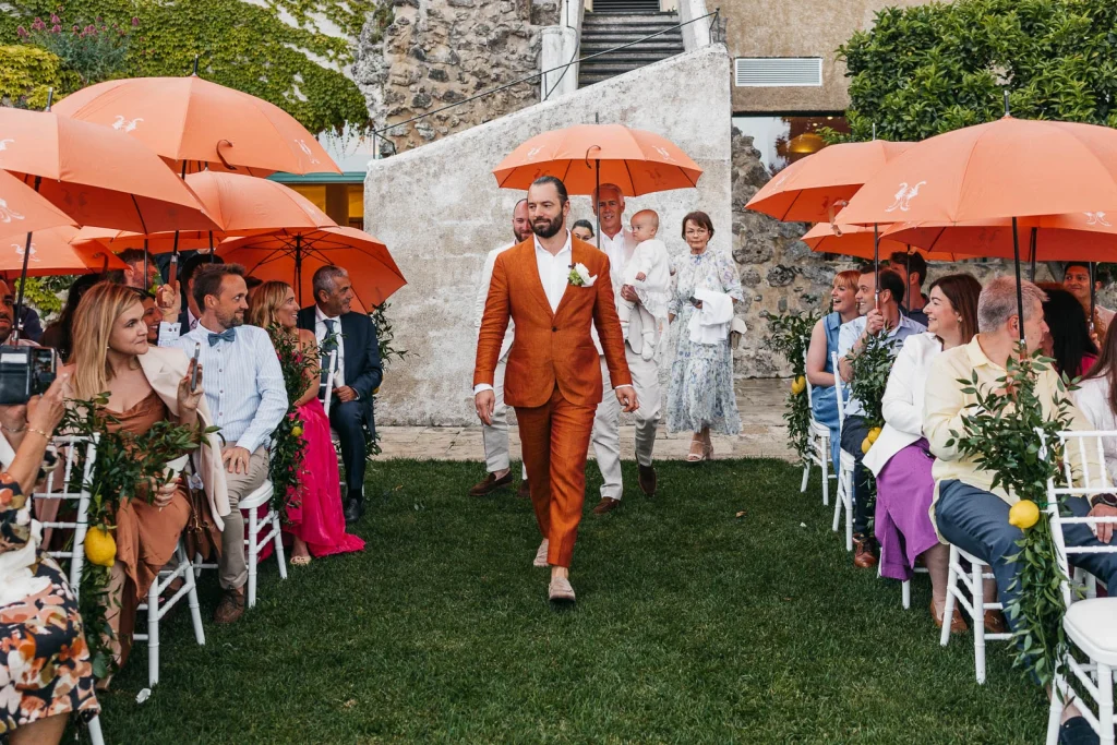 Ravello Wedding at Belmond Hotel Caruso – Amalfi Coast Destination Wedding 34 Groom Brendan walking down the aisle in a rust-colored suit
