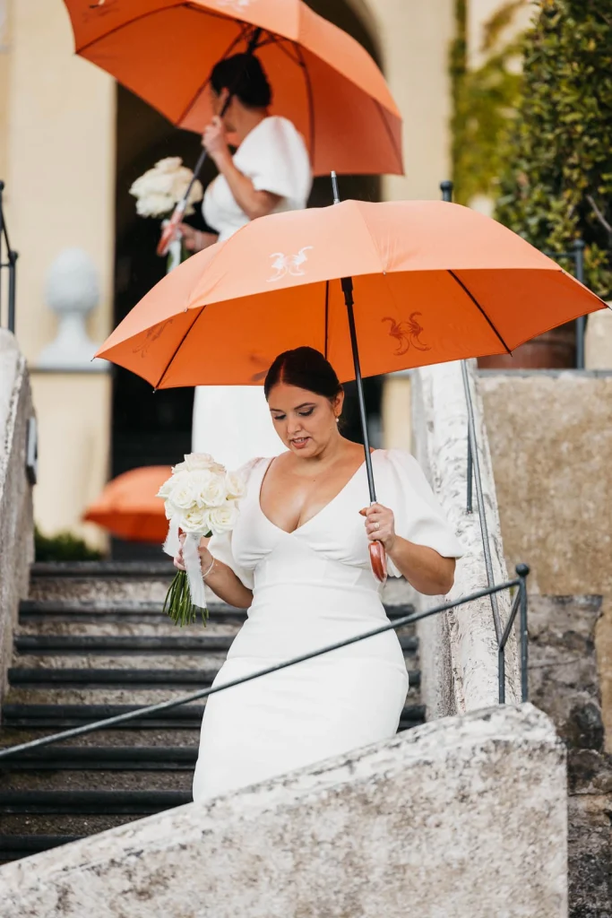 Ravello Wedding at Belmond Hotel Caruso – Amalfi Coast Destination Wedding 35 Bride smiling while holding her bouquet and umbrella