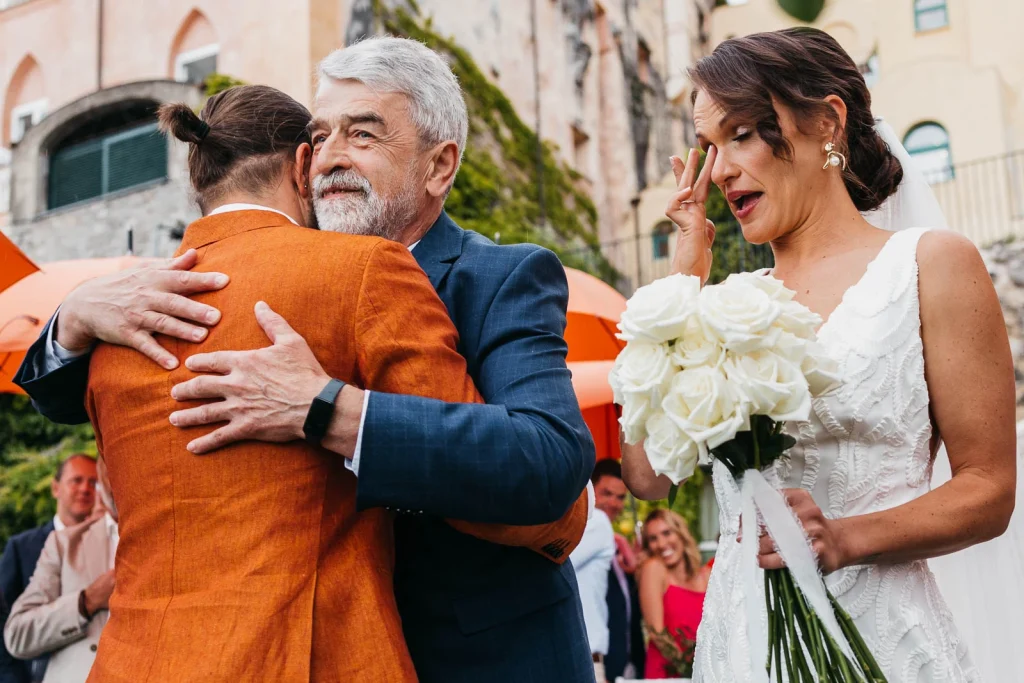 Ravello Wedding at Belmond Hotel Caruso – Amalfi Coast Destination Wedding 39 Groom hugging bride’s father warmly