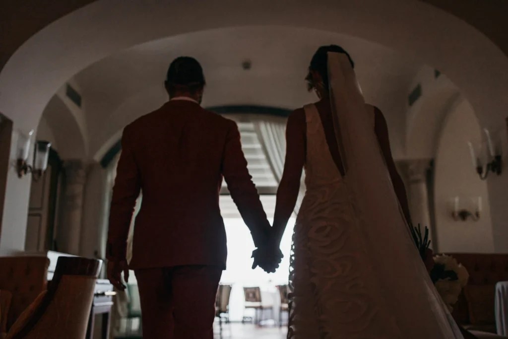 Ravello Wedding at Belmond Hotel Caruso – Amalfi Coast Destination Wedding 46 Bride and groom walking hand in hand into the reception venue