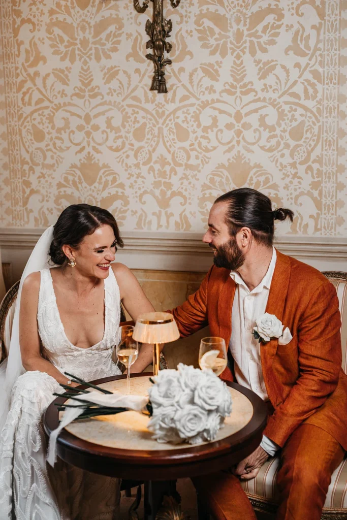 Ravello Wedding at Belmond Hotel Caruso – Amalfi Coast Destination Wedding 49 Bride and groom laughing while sharing a meal indoors