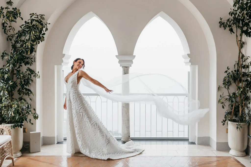 Ravello Wedding at Belmond Hotel Caruso – Amalfi Coast Destination Wedding 52 Bride posing joyfully on the hotel terrace