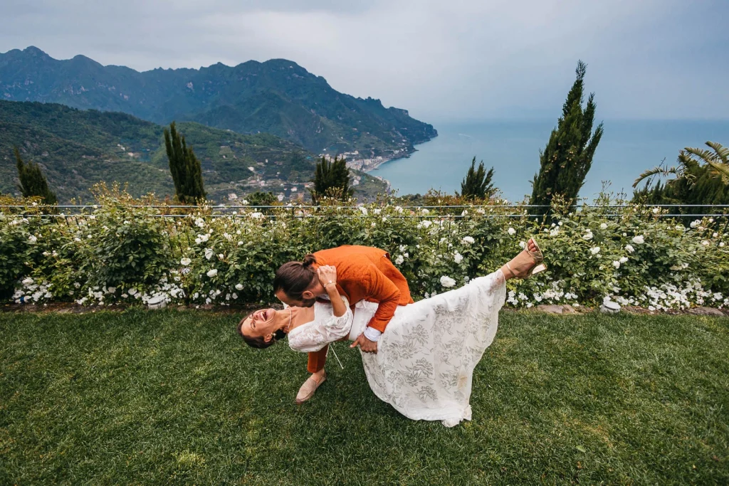 Ravello Wedding at Belmond Hotel Caruso – Amalfi Coast Destination Wedding 57 Groom dipping bride for a kiss with Ravello view