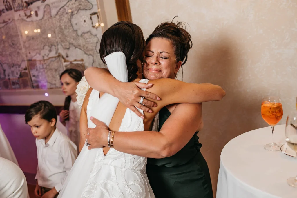 Ravello Wedding at Belmond Hotel Caruso – Amalfi Coast Destination Wedding 63 Bride hugging a friend during dinner