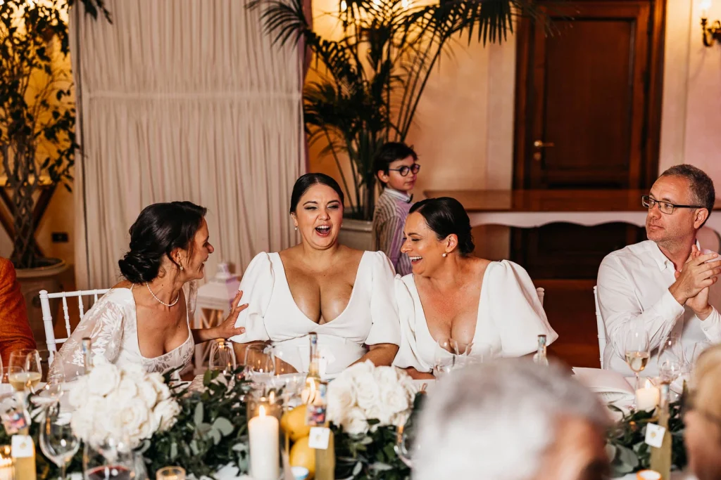 Ravello Wedding at Belmond Hotel Caruso – Amalfi Coast Destination Wedding 64 Bridesmaids laughing during dinner at the head table