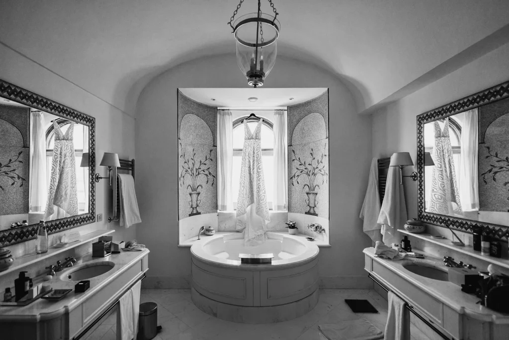 Ravello Wedding at Belmond Hotel Caruso – Amalfi Coast Destination Wedding 8 Black and white photo of a luxurious bathroom with arches and chandelier