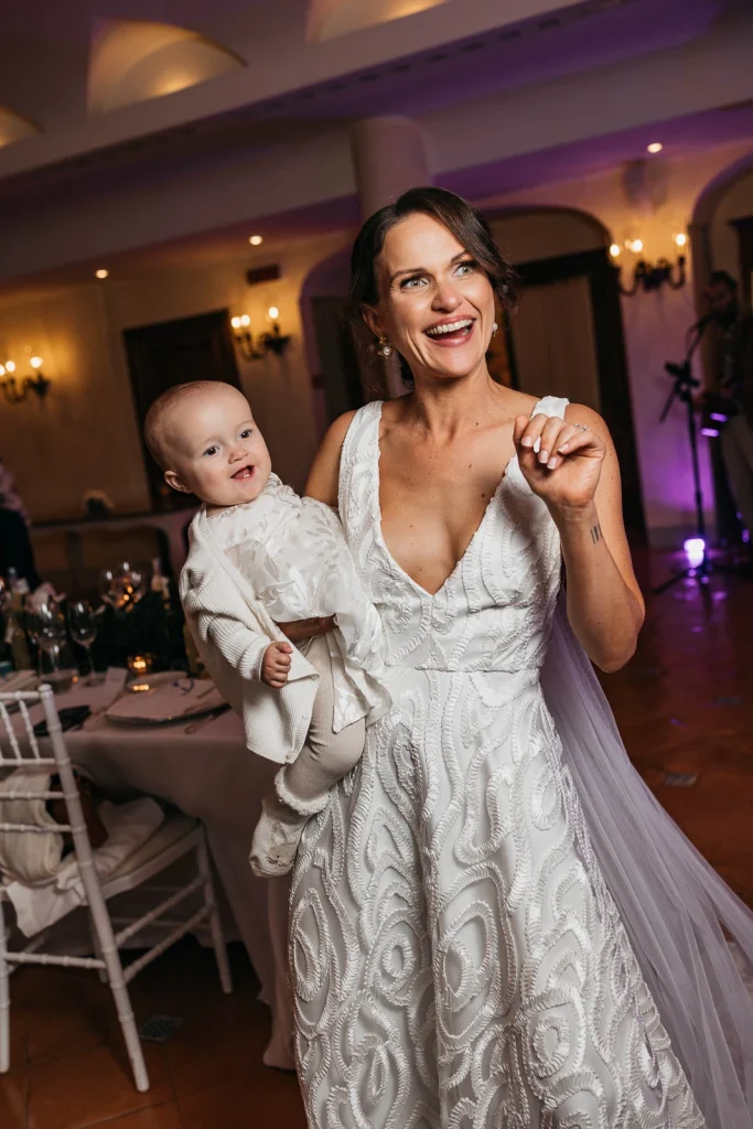 Ravello Wedding at Belmond Hotel Caruso – Amalfi Coast Destination Wedding 72 Bride holding Florence during the evening celebration