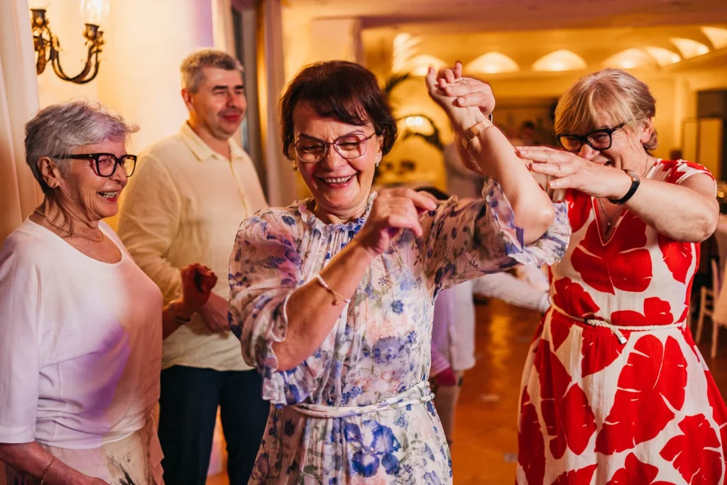 Ravello Wedding at Belmond Hotel Caruso – Amalfi Coast Destination Wedding 74 Guest dancing joyfully with her hands in the air