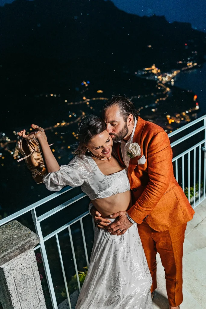 Ravello Wedding at Belmond Hotel Caruso – Amalfi Coast Destination Wedding 78 Groom holding champagne while bride laughs on a rooftop