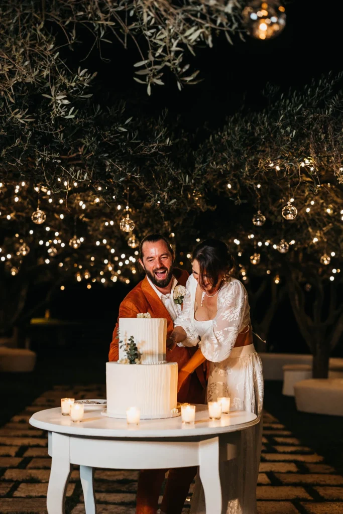 Ravello Wedding at Belmond Hotel Caruso – Amalfi Coast Destination Wedding 80 Groom laughing with bride while cutting the wedding cake