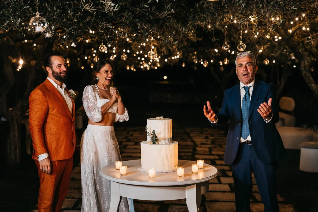 Ravello Wedding at Belmond Hotel Caruso – Amalfi Coast Destination Wedding 81 Bride and groom cutting the wedding cake under string lights