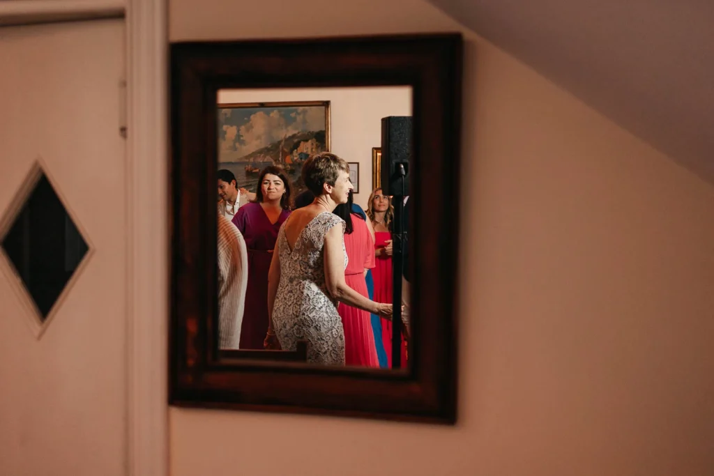 Ravello Wedding at Belmond Hotel Caruso – Amalfi Coast Destination Wedding 85 Guests seen through a mirror during the party