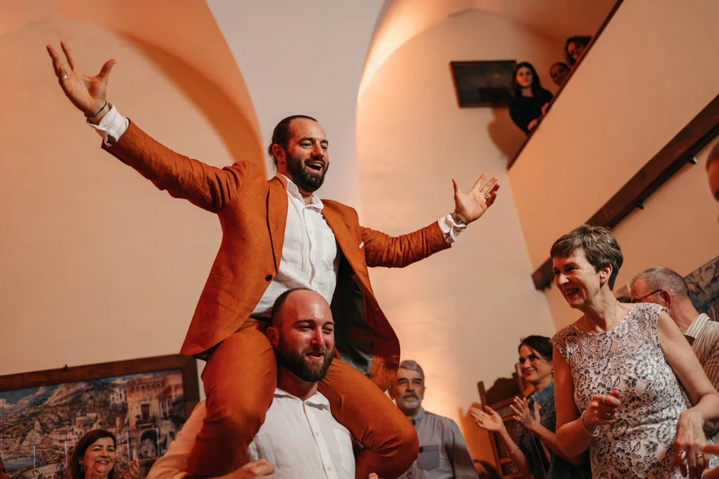 Ravello Wedding at Belmond Hotel Caruso – Amalfi Coast Destination Wedding 86 Groom dancing with arms raised during the party