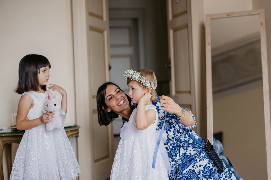 Dream Wedding at Villa Le Due Torrette in Erba: The Elegance of a Lake Como Celebration 18 Bride helping daughter get dressed for the ceremony at Villa Le Due Torrette