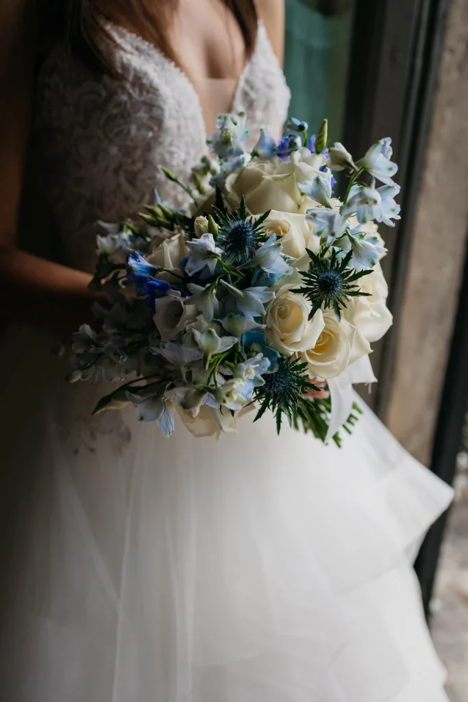 Dream Wedding at Villa Le Due Torrette in Erba: The Elegance of a Lake Como Celebration 25 Wedding bouquet with blue and white flowers at a Lake Como wedding