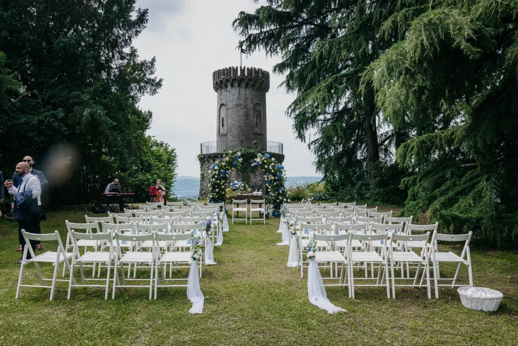 Dream Wedding at Villa Le Due Torrette in Erba: The Elegance of a Lake Como Celebration 28 Outdoor civil ceremony setup in front of the tower at Villa Le Due Torrette
