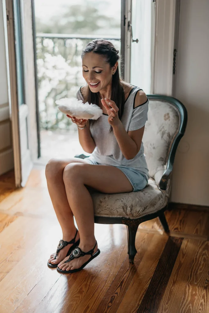 Dream Wedding at Villa Le Due Torrette in Erba: The Elegance of a Lake Como Celebration 4 Bride smiling while enjoying a drink during wedding preparations at Villa Le Due Torrette