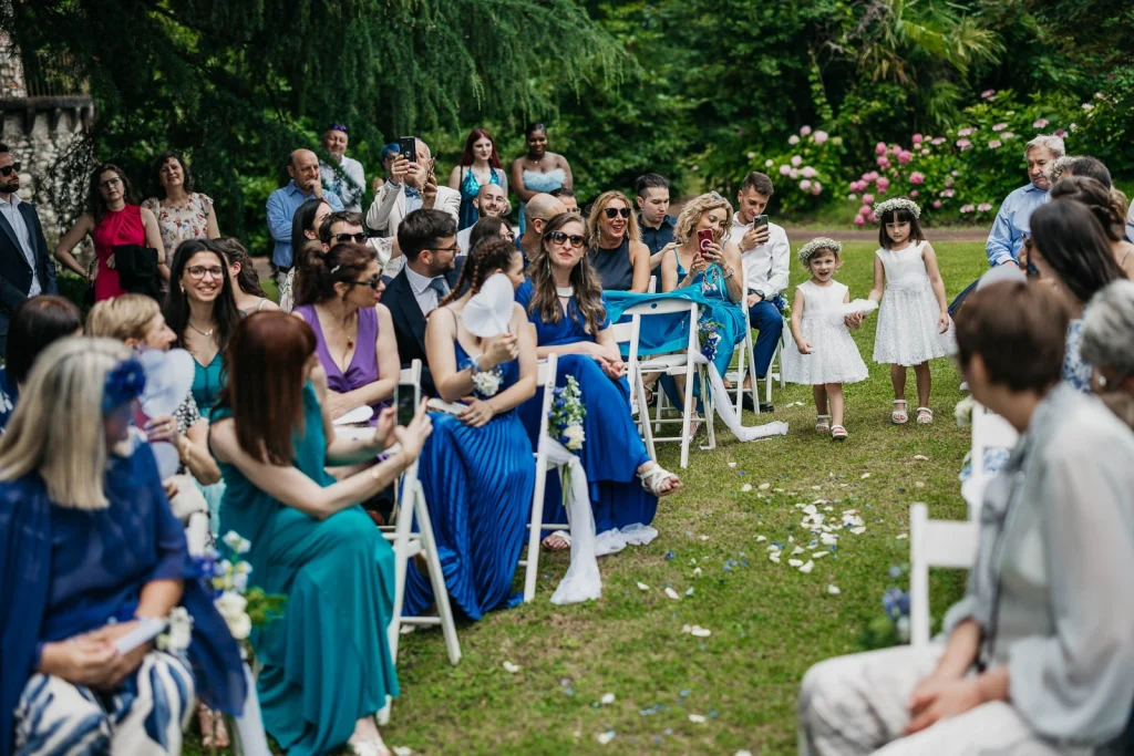 Dream Wedding at Villa Le Due Torrette in Erba: The Elegance of a Lake Como Celebration 41 Guests watching the ceremony as the bride reads her vows