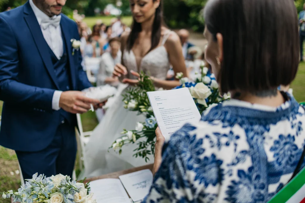 Dream Wedding at Villa Le Due Torrette in Erba: The Elegance of a Lake Como Celebration 42 Close-up of ceremony booklet and floral decor during the exchange of vows