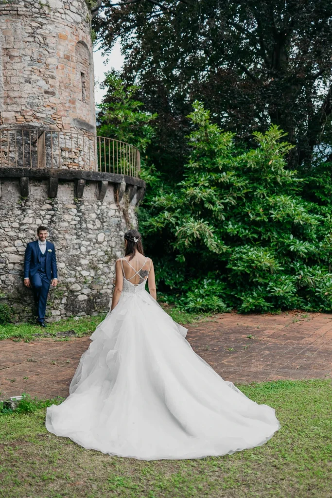 Dream Wedding at Villa Le Due Torrette in Erba: The Elegance of a Lake Como Celebration 52 Bride posing in front of the tower at Villa Le Due Torrette