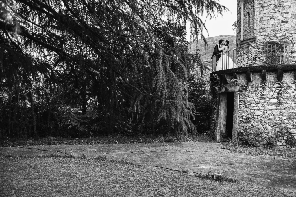 Dream Wedding at Villa Le Due Torrette in Erba: The Elegance of a Lake Como Celebration 54 Black and white image of bride near a cypress tree in Villa Le Due Torrette