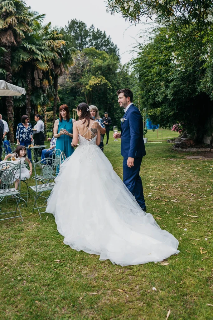 Dream Wedding at Villa Le Due Torrette in Erba: The Elegance of a Lake Como Celebration 63 Couple walking on villa lawn, bride smiling at groom in Erba