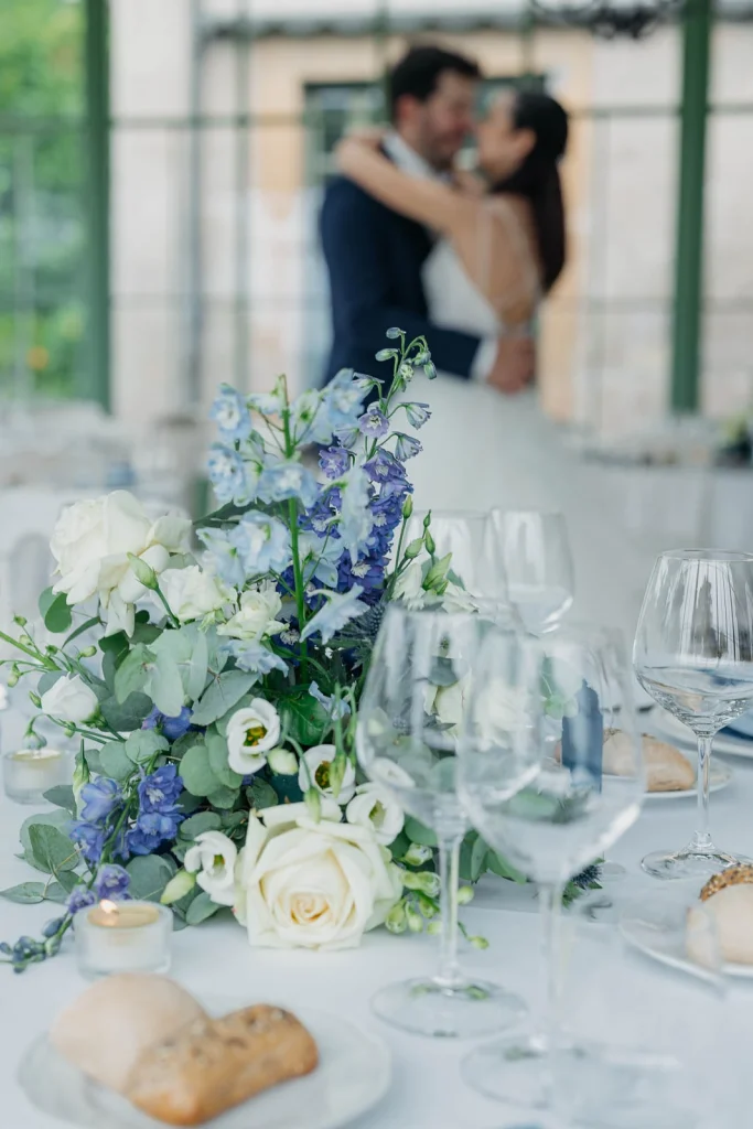 Dream Wedding at Villa Le Due Torrette in Erba: The Elegance of a Lake Como Celebration 69 Floral centrepieces with blue and white flowers at Villa Le Due Torrette