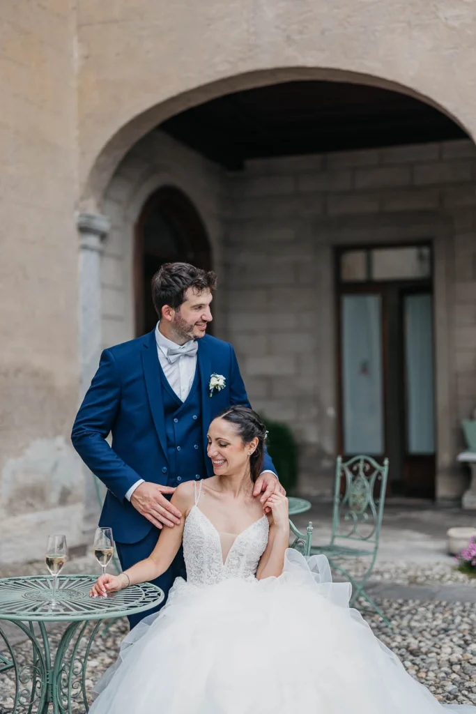 Dream Wedding at Villa Le Due Torrette in Erba: The Elegance of a Lake Como Celebration 60 Groom talking with bride near villa arch at Lake Como location