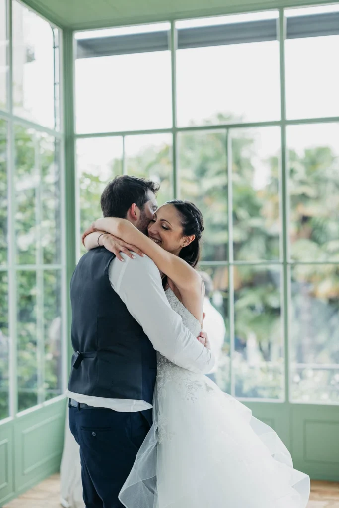 Dream Wedding at Villa Le Due Torrette in Erba: The Elegance of a Lake Como Celebration 76 Bride and groom share first dance inside Villa Le Due Torrette glass hall