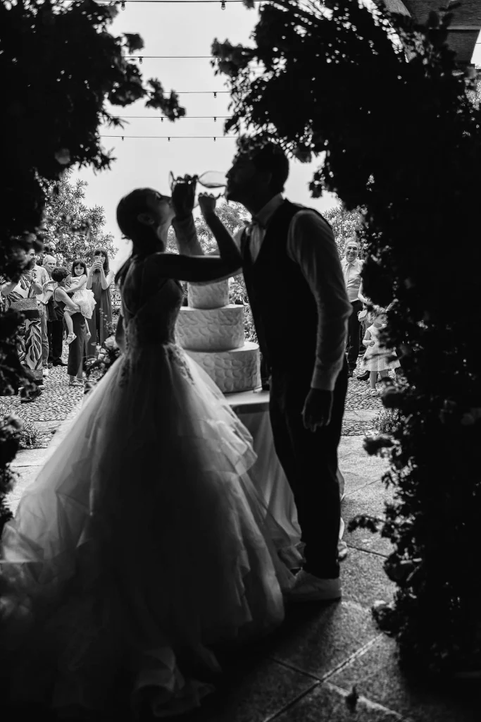 Dream Wedding at Villa Le Due Torrette in Erba: The Elegance of a Lake Como Celebration 82 Black and white image of bride tossing bouquet at Lake Como wedding